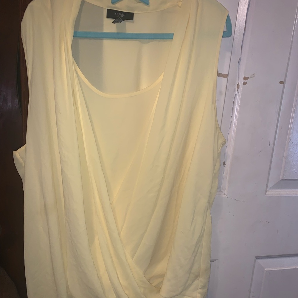 Yellow tank top with uneven cuts.